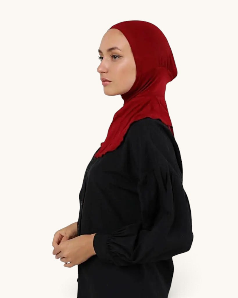 LOSYANA underscarf in bone red worn by a model, providing comfortable coverage under a hijab.