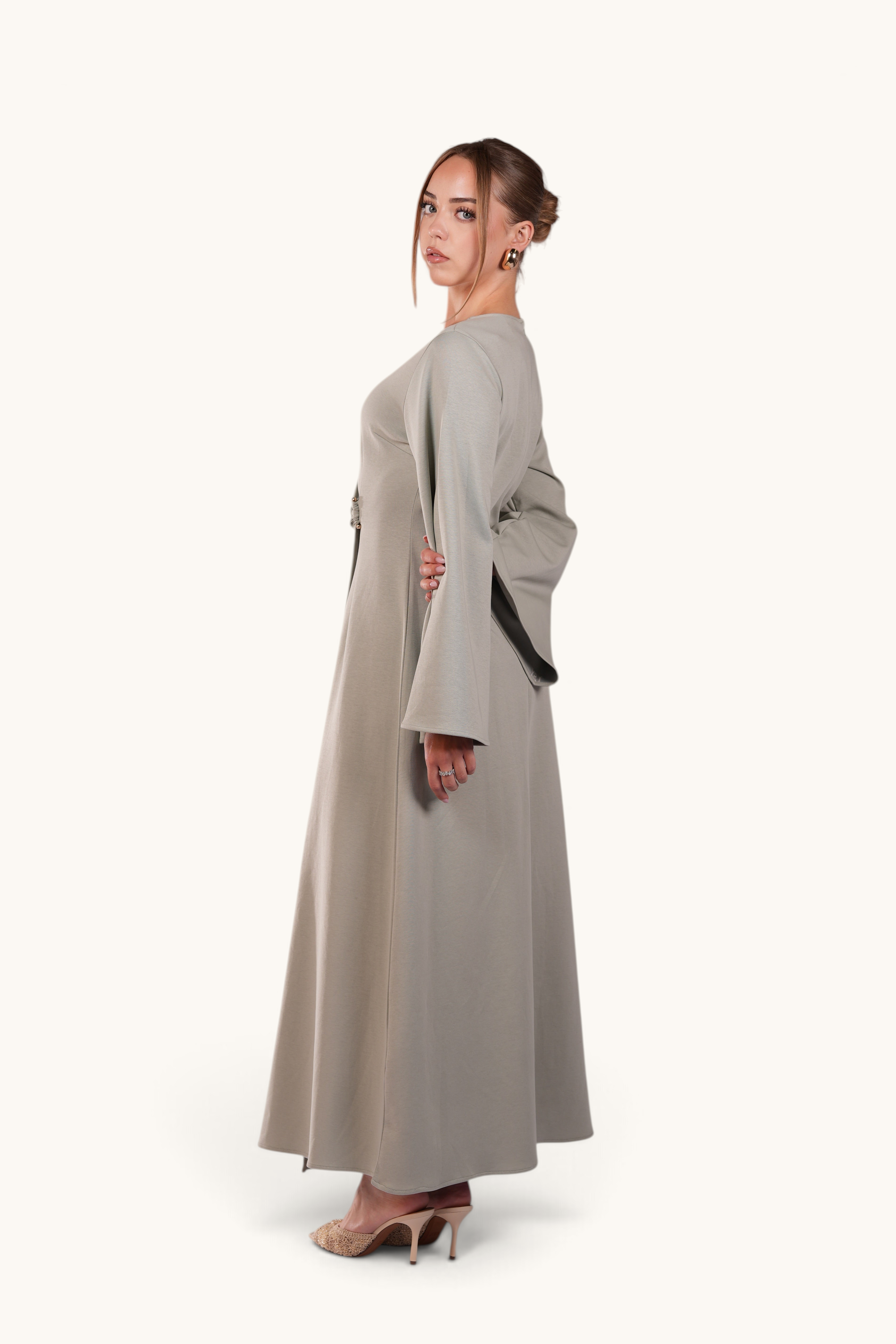 LOSYANA Valencia mint maxi dress with trumpet sleeves and gold waist detail worn by a model on a white background
