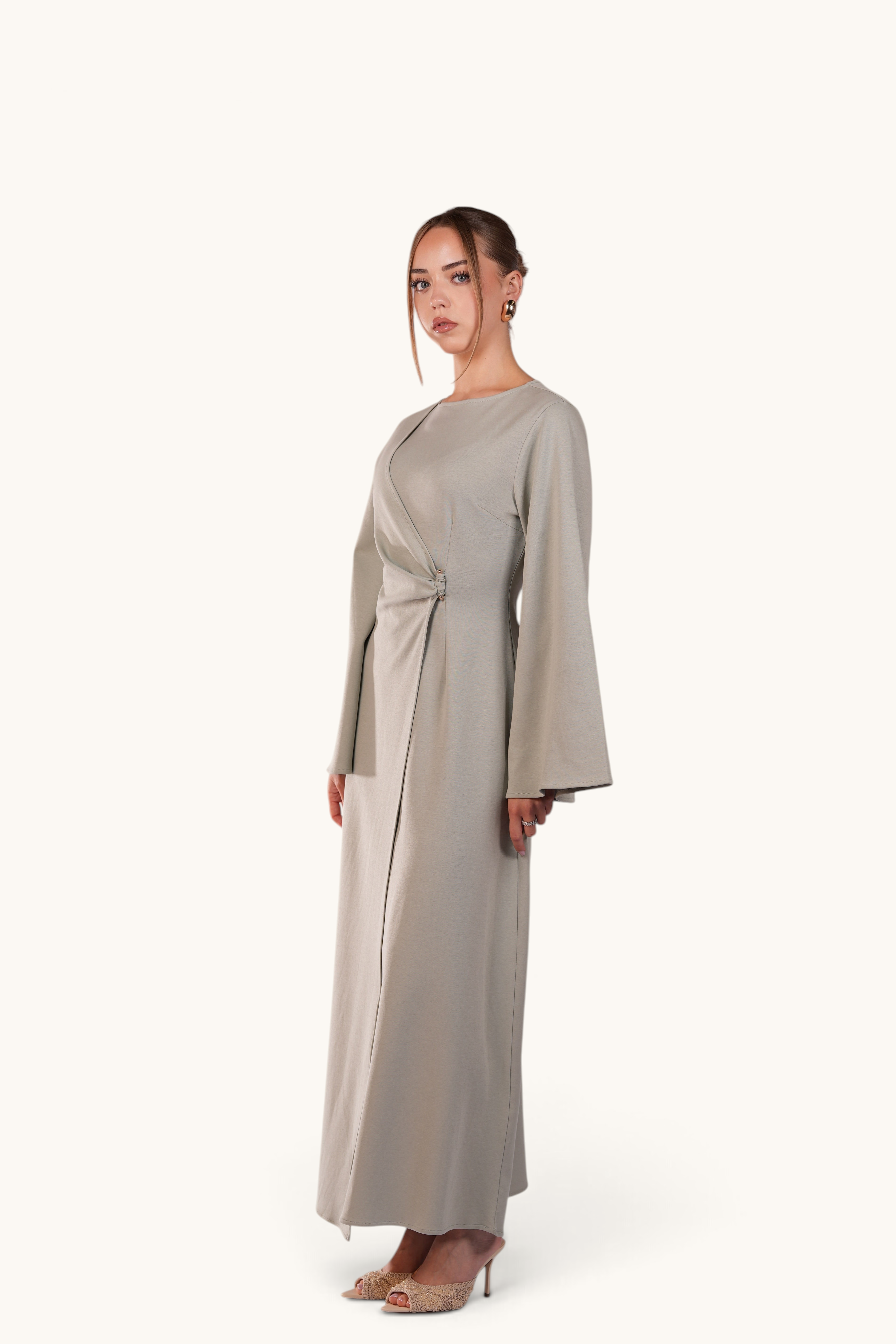 LOSYANA Valencia mint maxi dress with trumpet sleeves and gold waist detail worn by a model