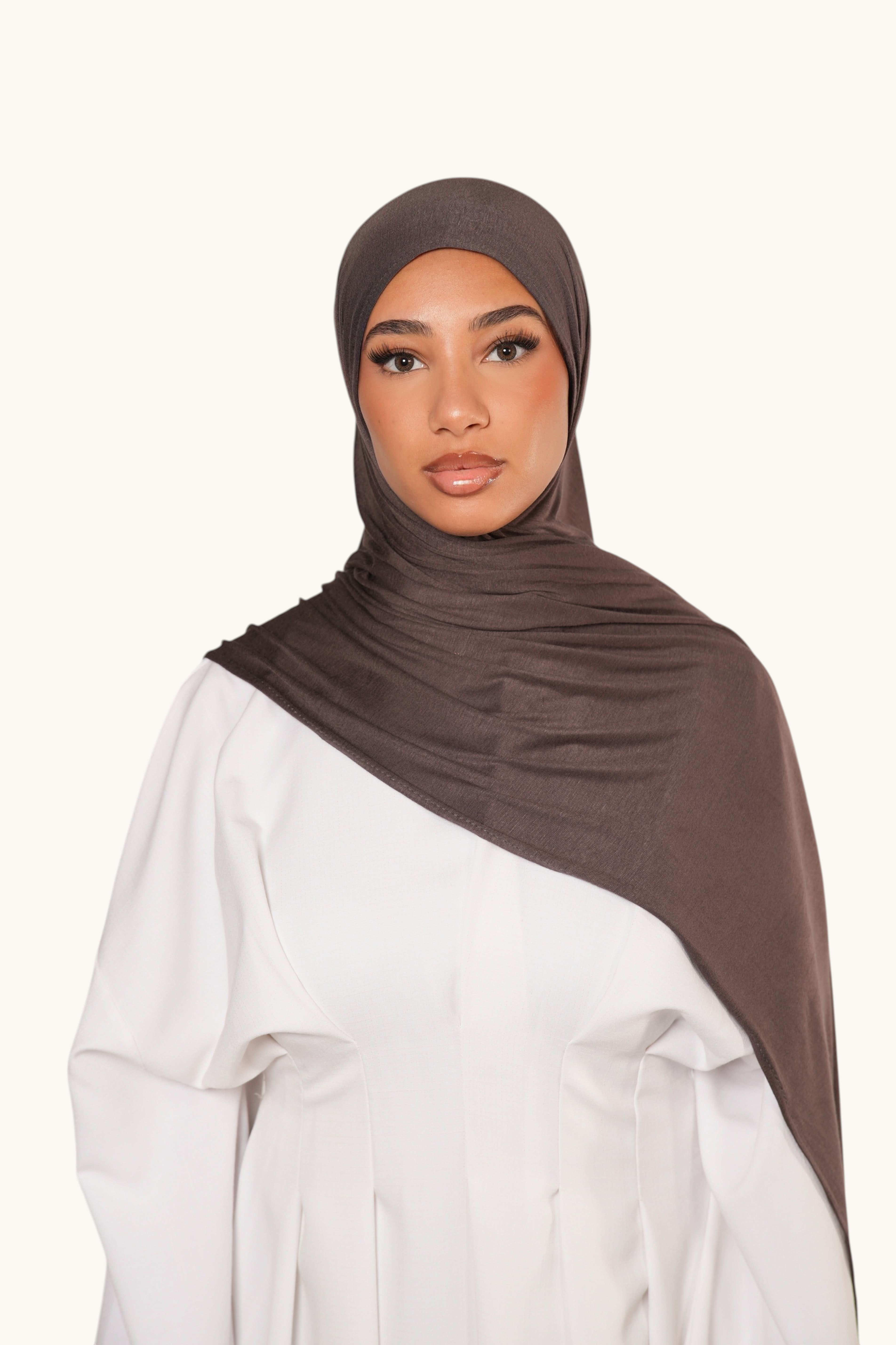 Model wearing a brown sugar LOSYANA Vela Jersey hijab, a soft and breathable lightweight fabric scarf.