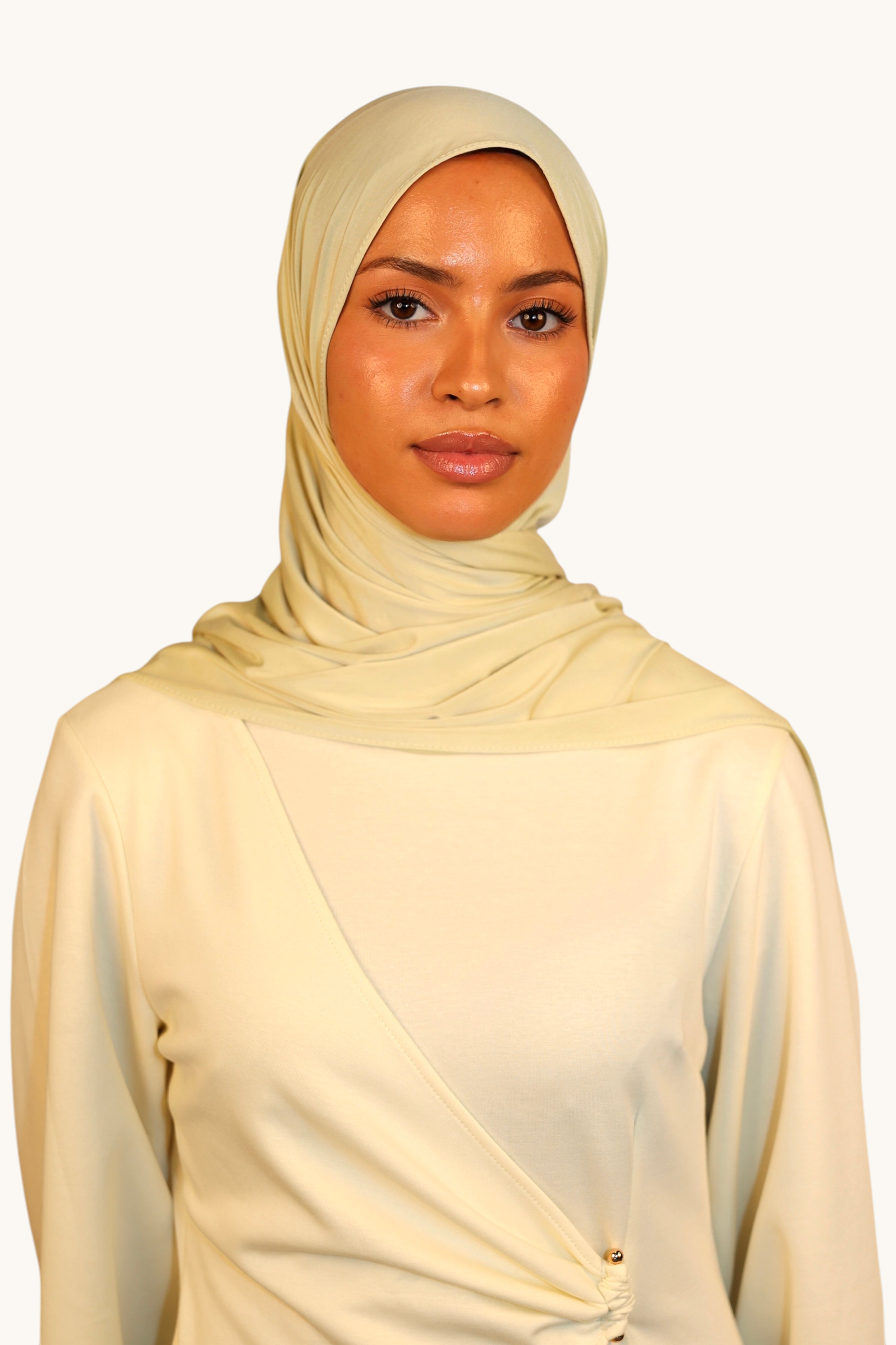 Model wearing a light lime LOSYANA Vela Jersey hijab made of soft, breathable fabric with a draped wrap design.