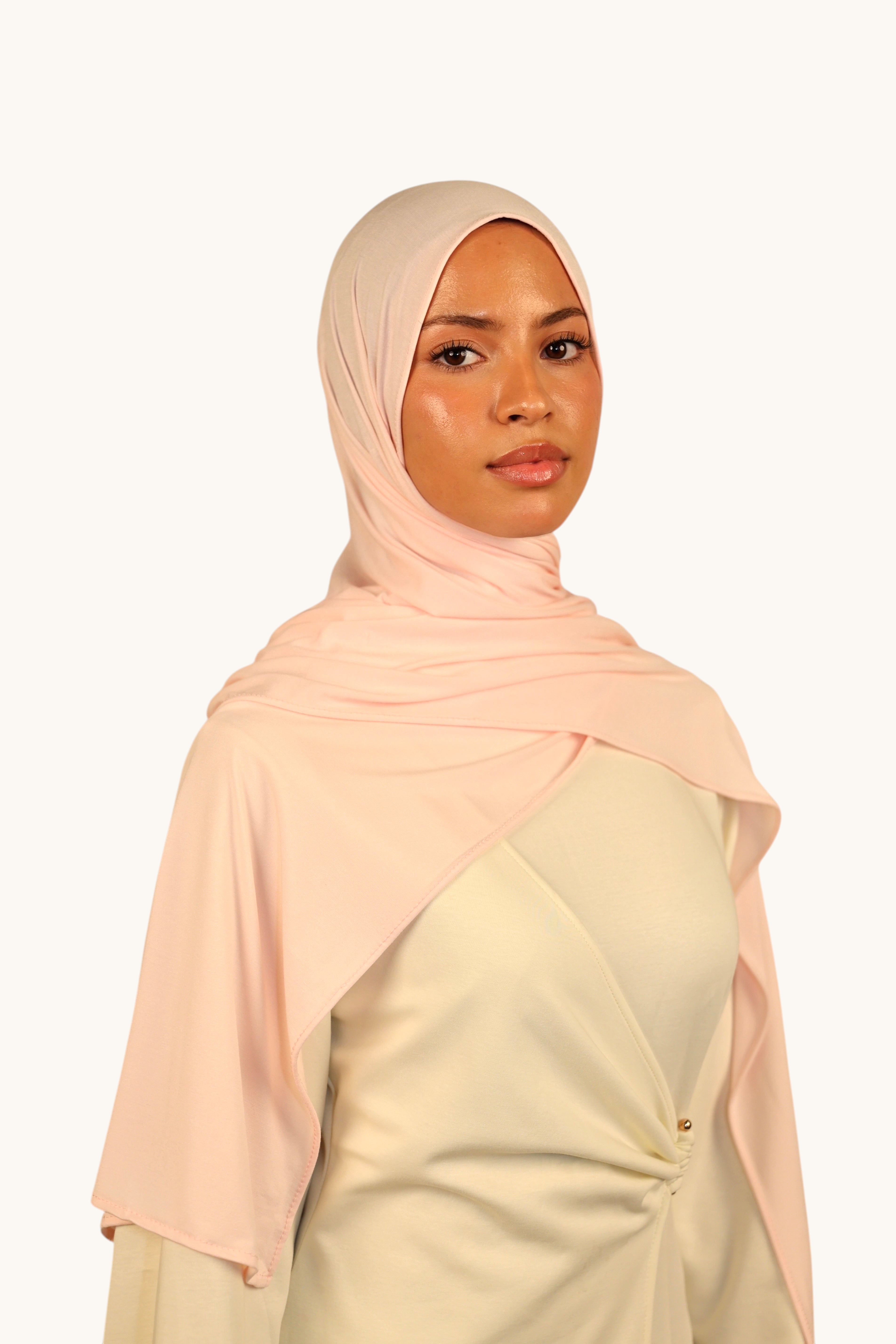 Model wearing a light rose LOSYANA Vela Jersey hijab, crafted from soft, breathable fabric for versatile styling.