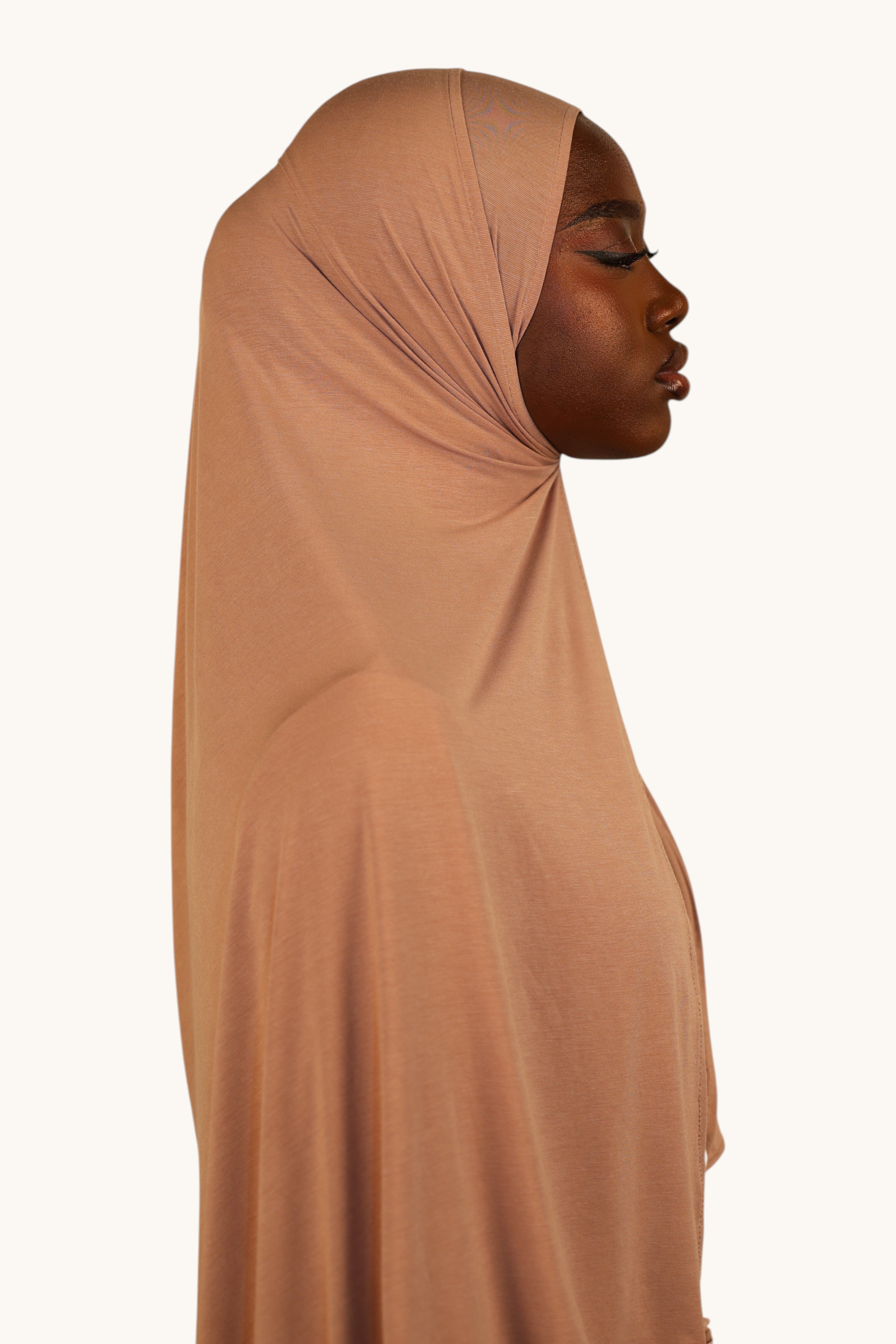 Model wearing a LOSYANA Vela Jersey in old rose, a soft, lightweight, breathable fabric hijab in a side profile view.