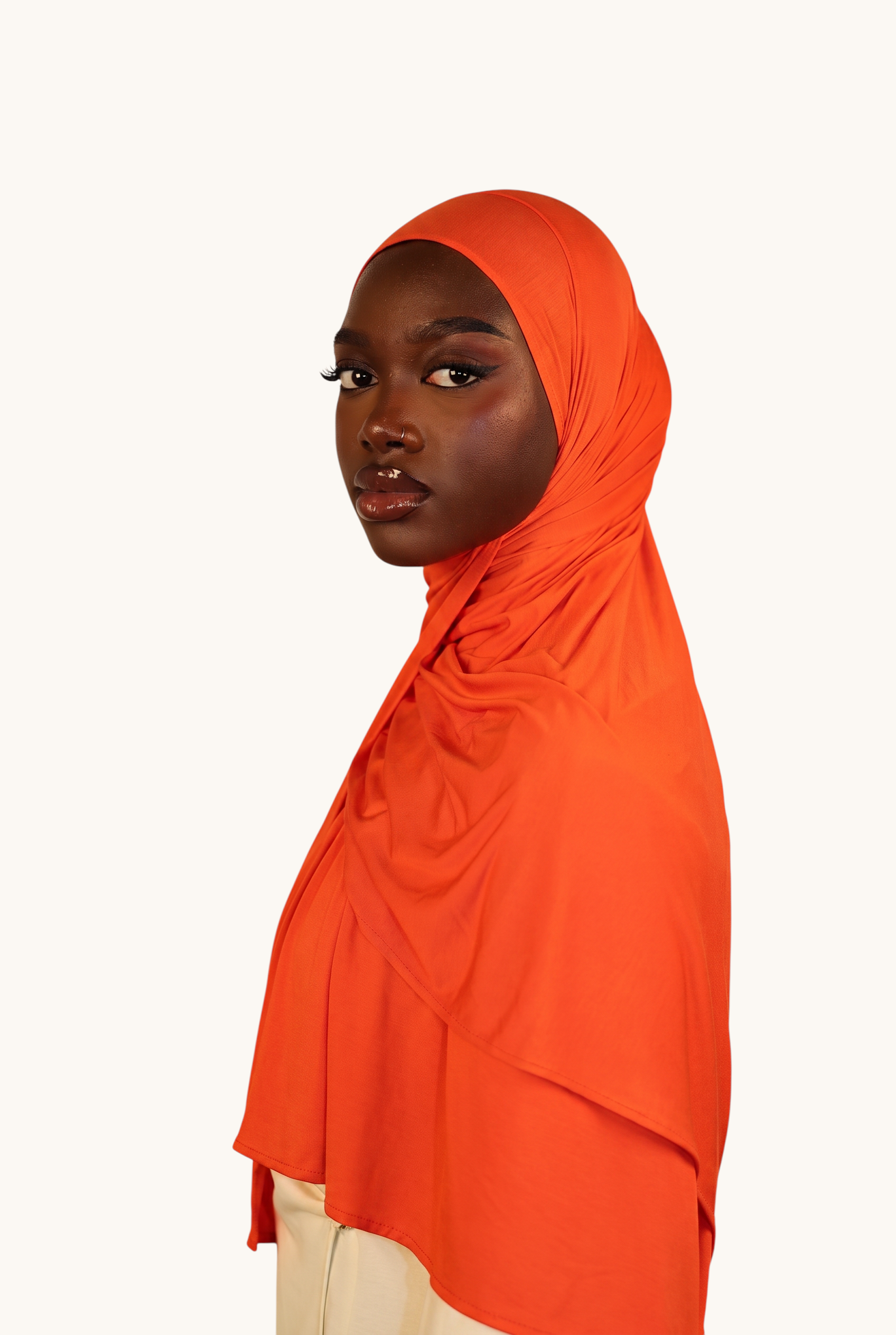 Model wearing a vibrant orange LOSYANA Vela Jersey hijab made from soft, breathable, lightweight fabric.