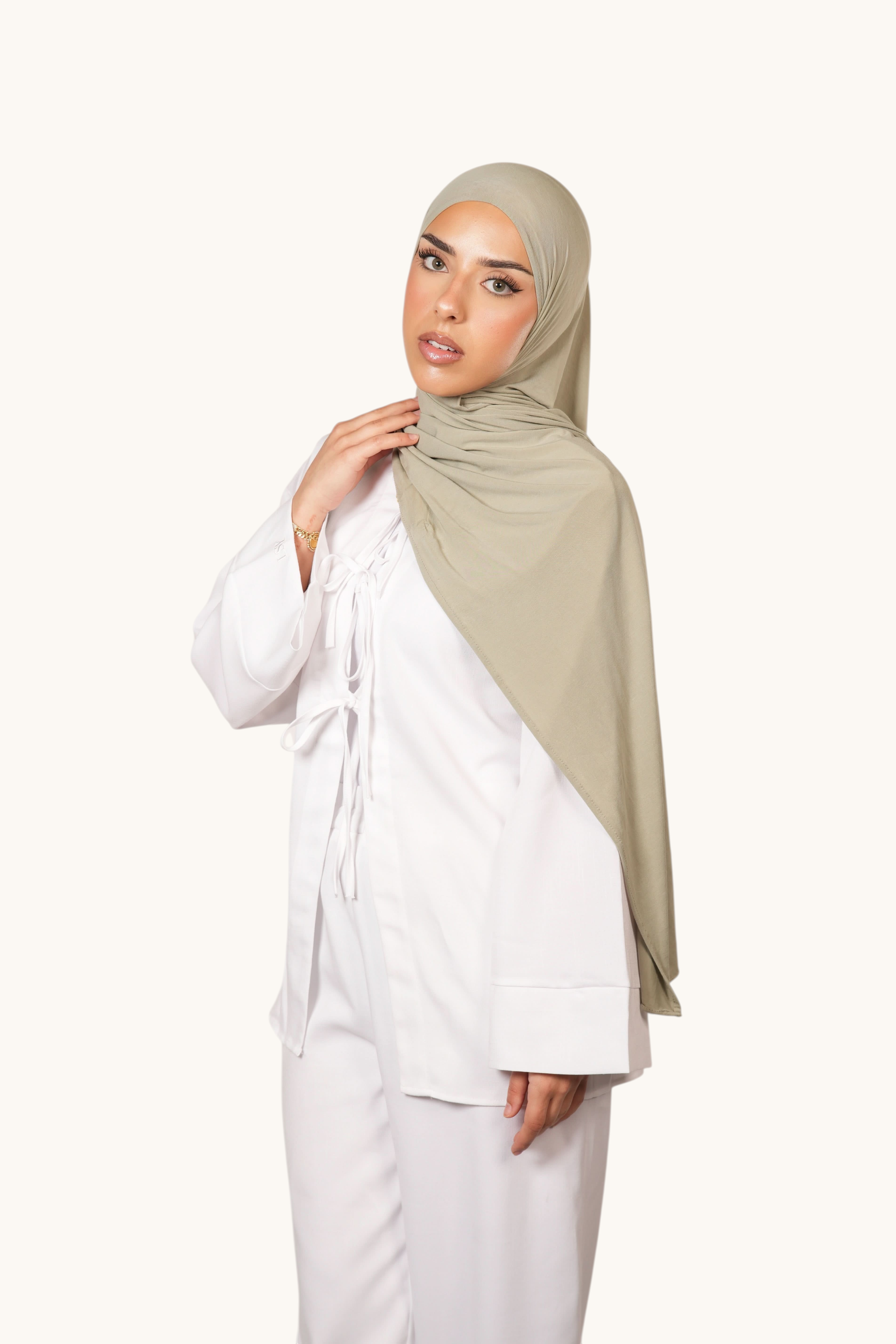 Model wearing a LOSYANA Vela Jersey in pistachio, a lightweight, breathable, and soft fabric hijab.