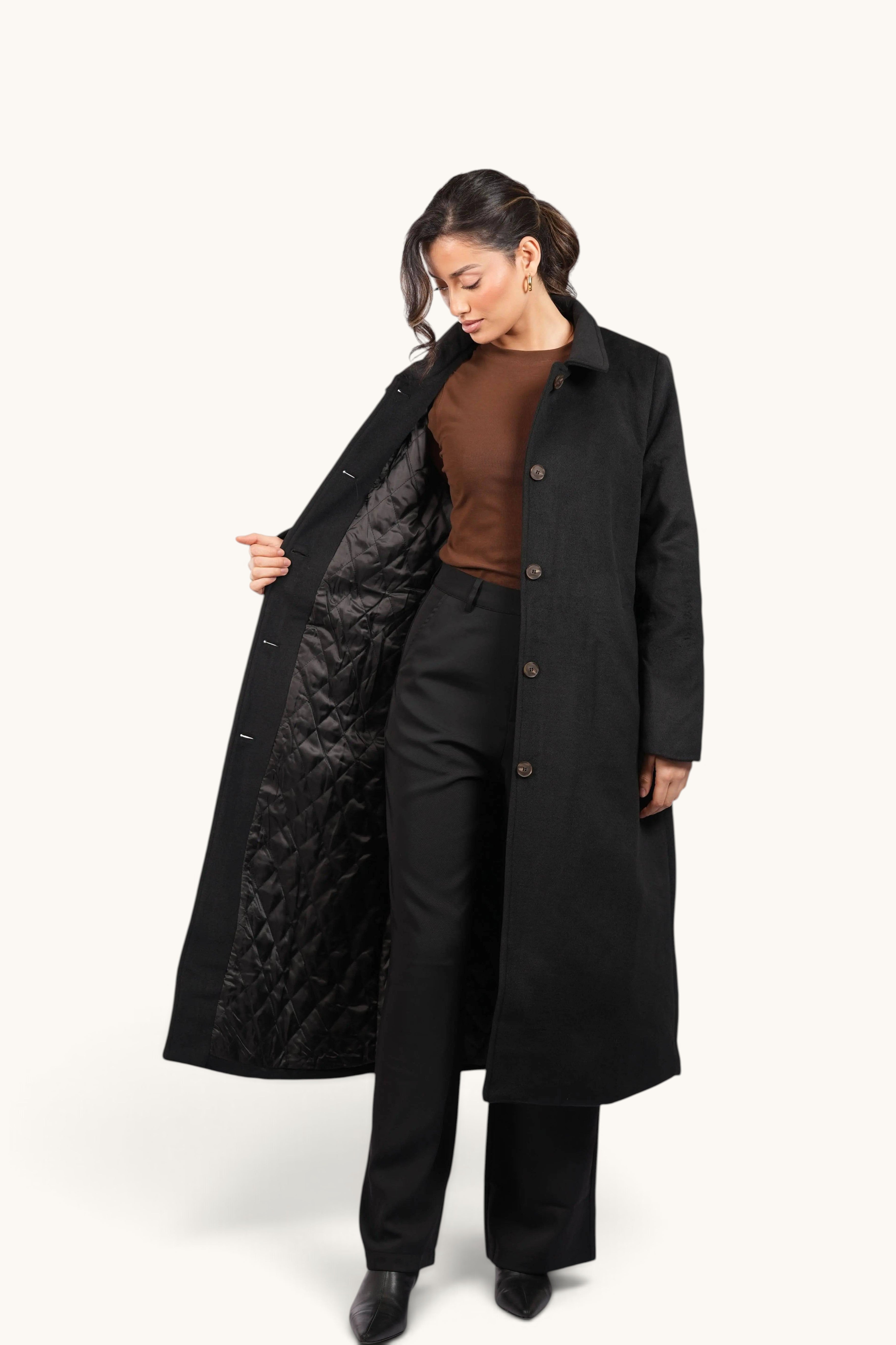 Model wearing a black LOSYANA Vienna coat with a quilted interior lining, showcasing an elegant long-cut design.