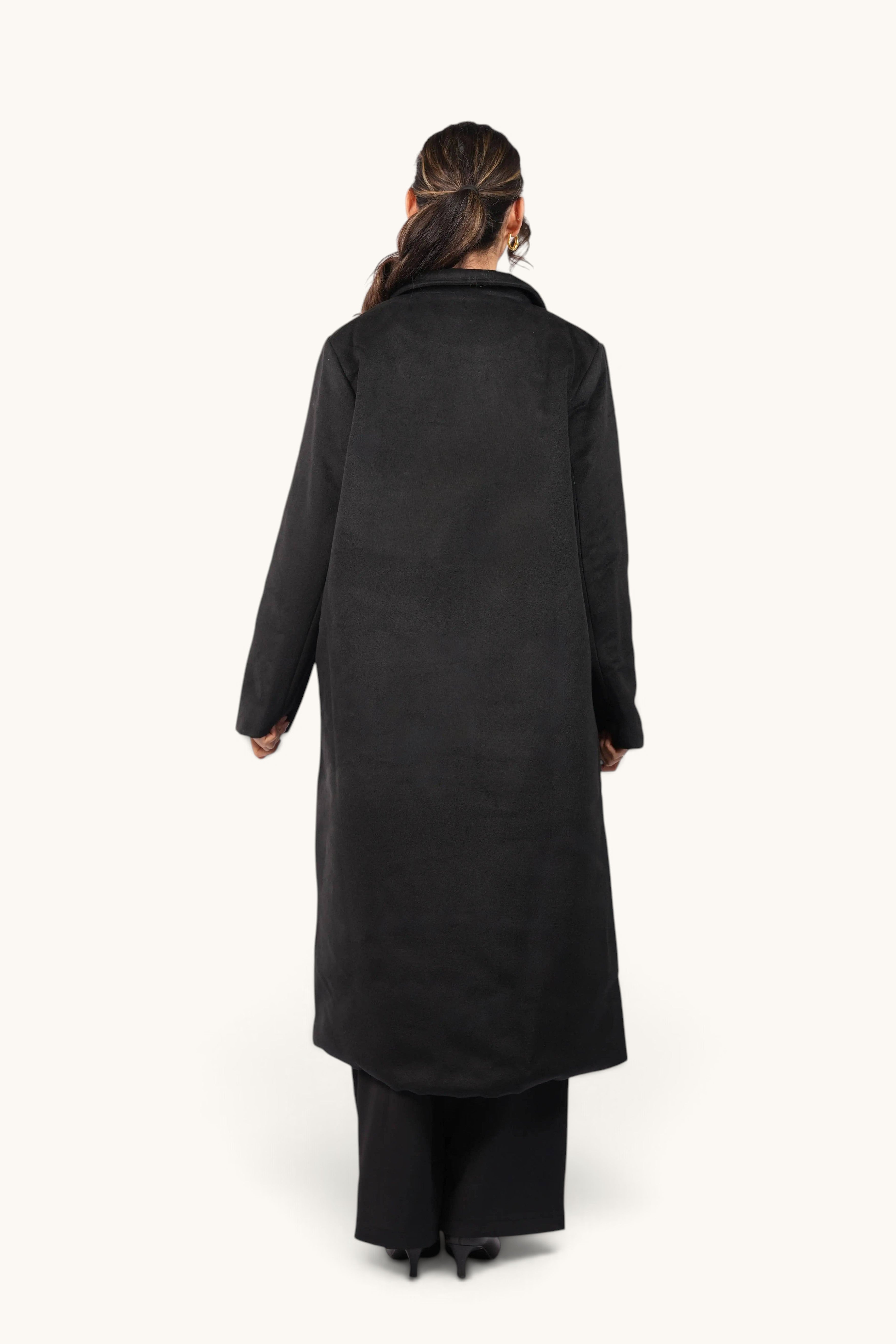 Back view of a woman wearing the LOSYANA Vienna coat in black, featuring a long, elegant tailored silhouette.