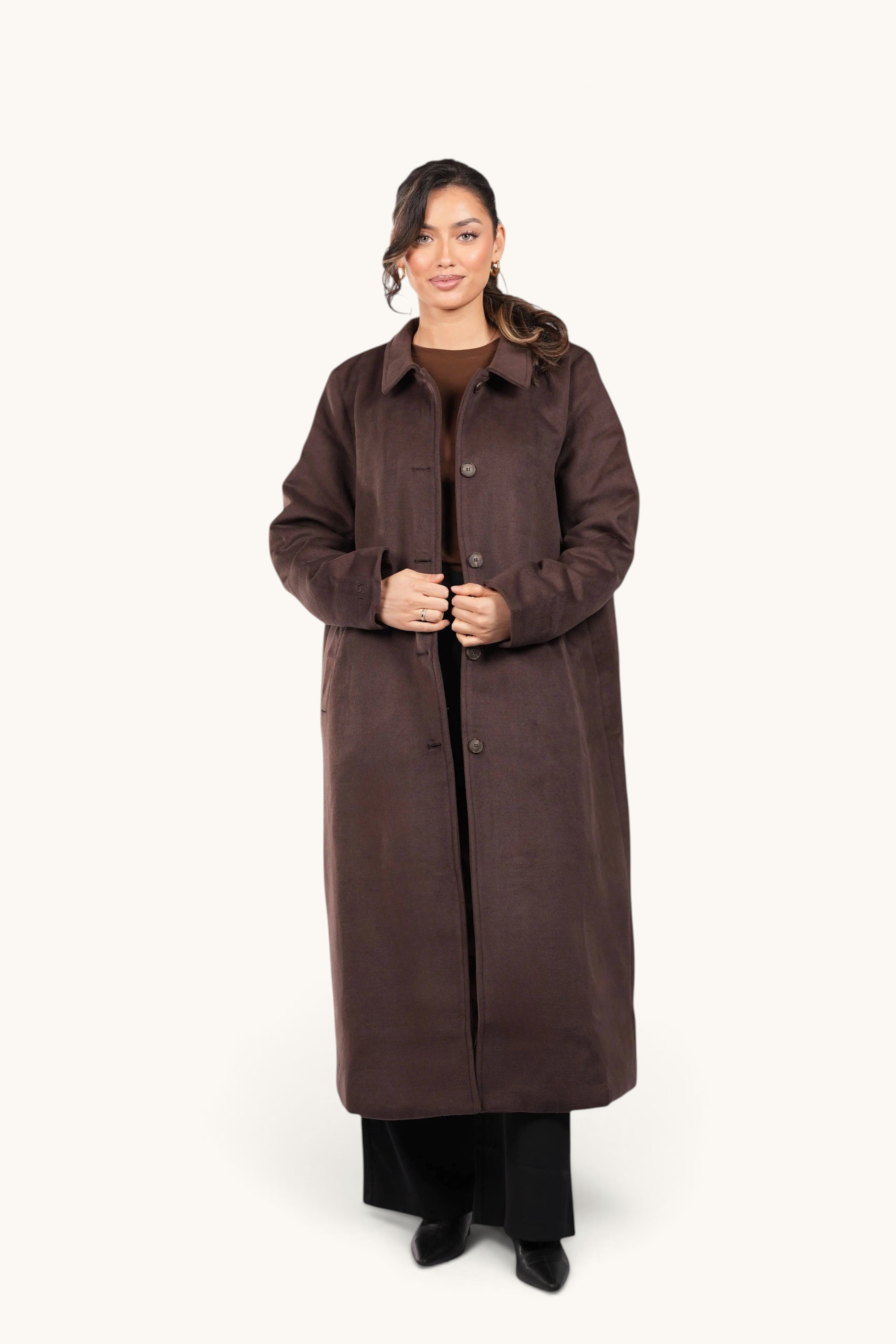Model wearing a long, espresso brown LOSYANA Vienna coat with a classic collar and button-down front.
