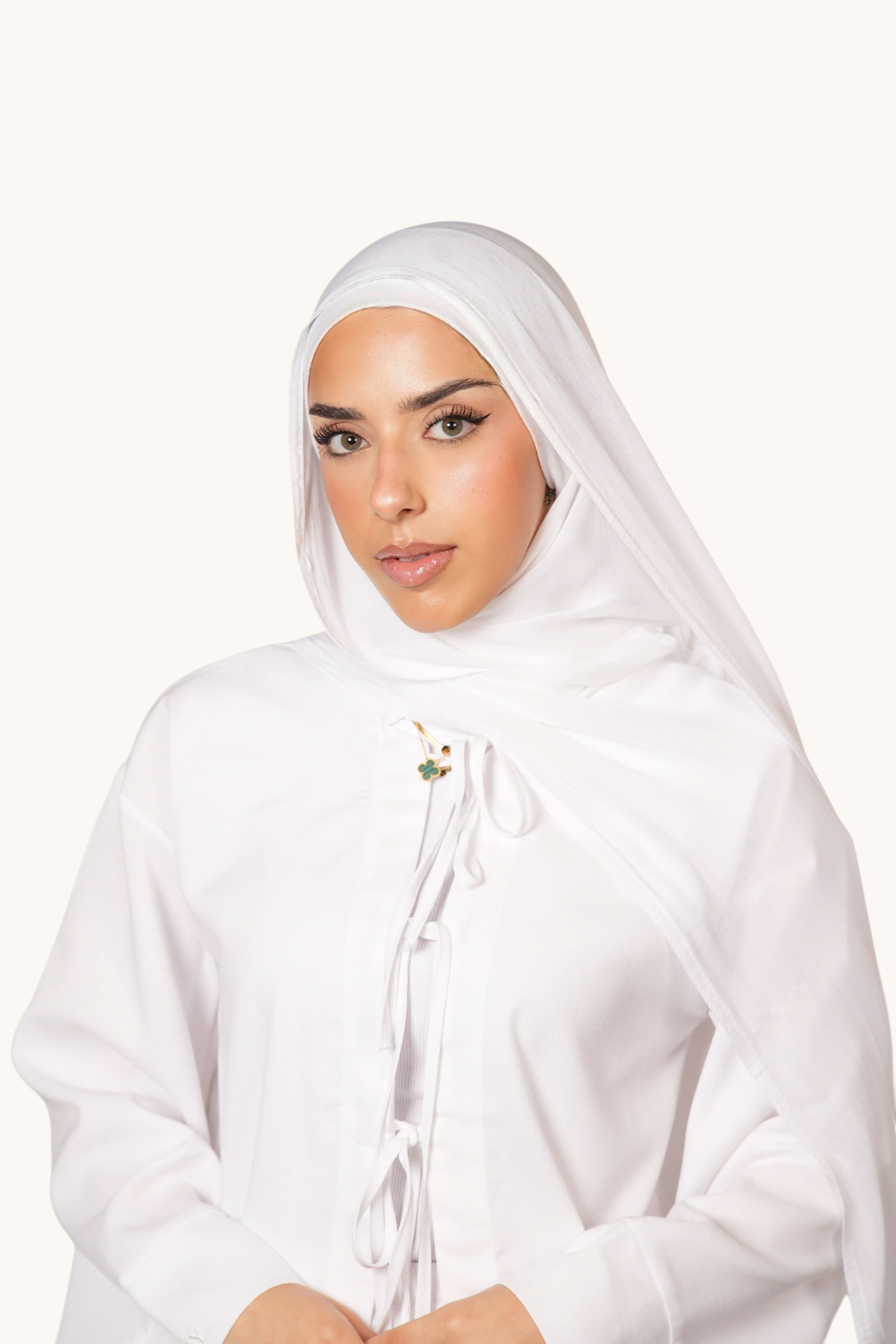 Model wearing a white LOSYANA lightweight modal hijab with a matching undercap, featuring a soft flowing drape.