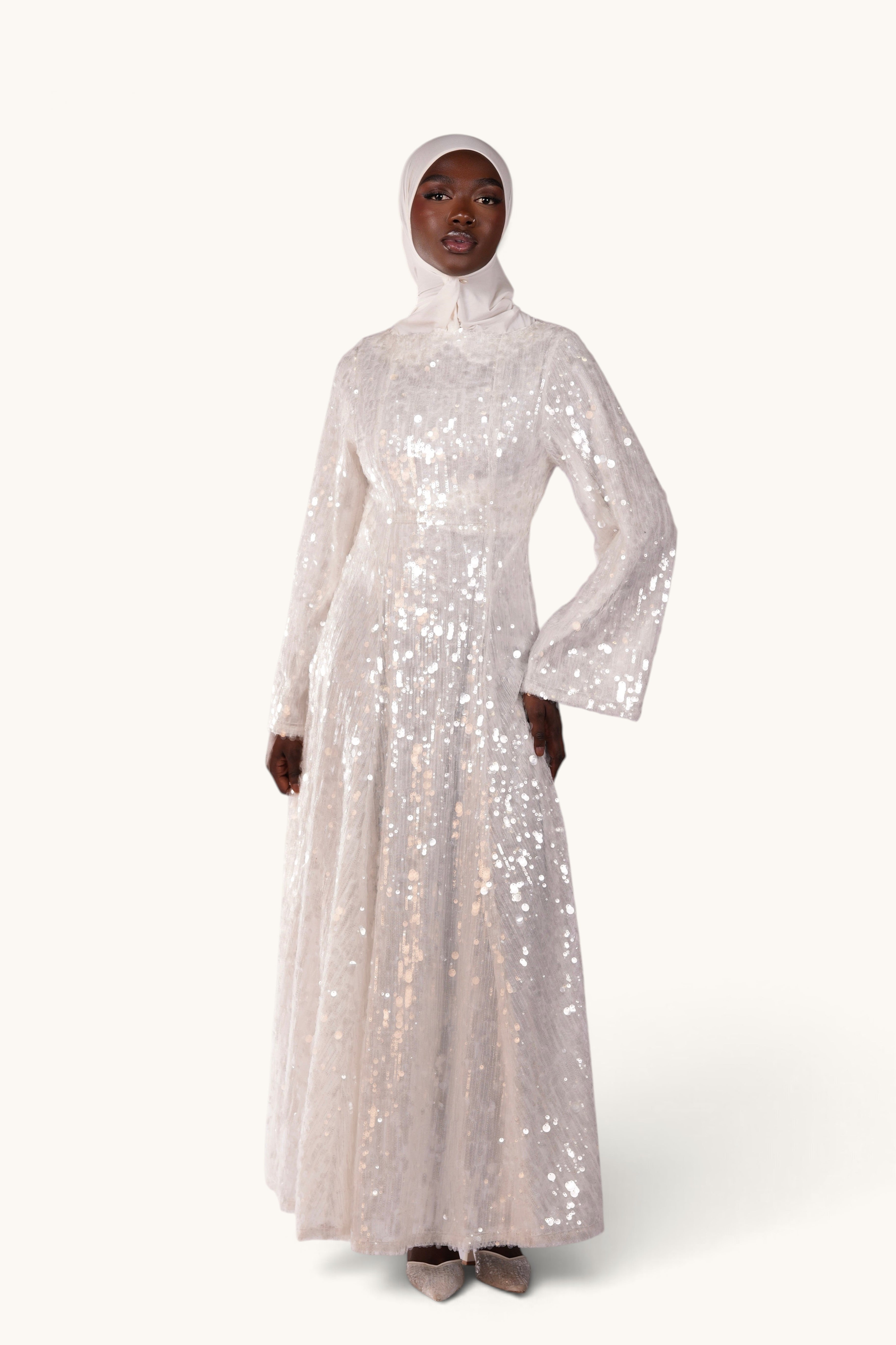 LOSYANA white sequin A-line evening dress with trumpet sleeves worn by a model in a hijab